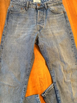 Jack & Jones Relaxed Chris ljusblå jeans - Ljusblå jeans från Jack & Jones, modell Relaxed Chris. Klassisk femficksdesign, raka ben och avslappnad passform. Tillverkade i slitstarkt bomullsmaterial med knappgylf och snygga kontrastsömmar. Perfekta för en chill och avslappnad stil. Vid frågor är det bara att skriva eller angående pris!