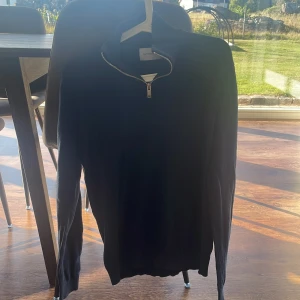 Mörkblå half zip tröja By TeeShoppen - Mörkblå långärmad tröja från By TeeShoppen med hög krage och snygg silverfärgad half zip-dragkedja. 