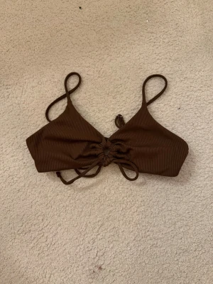 Brun bikini överdel - Säljer en brun bikini överdel. Snörning i mitten. Shein