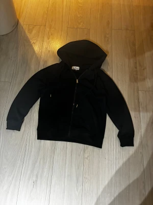 Svart Stone Island tröja  - Svart hoodie från Stone Island i storlek M men sitter som S. Tröjan har dragkedja framtill, huva med snörning och ribbade muddar. Materialet känns mjukt och är troligtvis bomull och polyester. Klassisk stil med två knappar på ena ärmen för jag tappat bort logan så Därför är priset så lågt.        Pris kan diskuteras vid snabb affär!!!!!