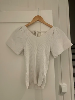 topp  - fin ribbad vit topp från Vero Moda i st xs men öppning i ryggen och puff armar