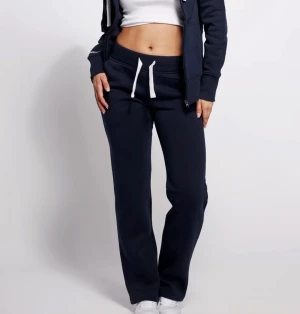 Mörkblå russemerch byxor - Snygga mörkblå russemerch mjukisbyxor i storlek xs och modellen girl straight med vit snörning, låg midja och raka ben. Inga defekter mer än att dom tappat färgen lite! Har även matchande zip hoodien i xs som jag också kan tänka mig sälja för 550kr eller hela settet för 850kr  💕 Kolla gärna in mina andra annonser