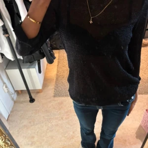 Svart stickad top med öppen rygg - Snygg svart transparent top från Gina tricot i storlek M sitter även fint på S!