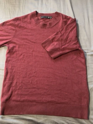 Vinröd stickad tröja från Lager 157 - Säljer en vinröd stickad tröja från Lager 157 med rund halsringning och ribbade muddar vid ärmslut och nederkant. Storlek S