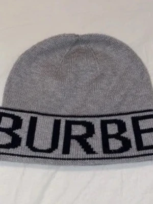 burberry cap  - Stylish and comfortable Burberry beanie in gray. Perfect for chilly days! The beanie is in great condition and has only been used a few times. Selling due to wardrobe clear-out. Grab a quality beanie from Burberry!