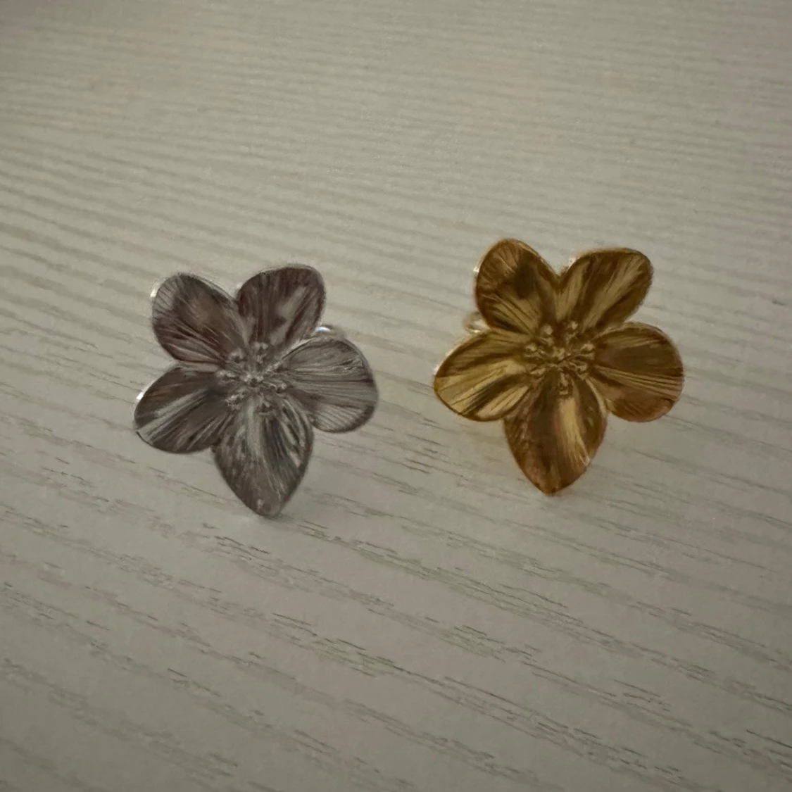 Blomformade ringar i guld och silver