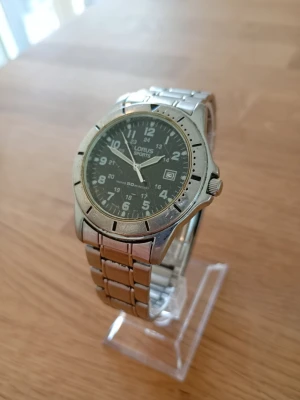 1990 Seiko Lorus Sports 40mm Herrklocka - Säljer en vintageklocka (90-tal) från japanska Lorus (Seiko) i gott använt skick enligt bilder. Fungerar bra, originalarmband i rostfritt stål, japanskt urverk, självlysande, vattentät till 50m, datumvisare, dykarutförande, osv. Behöver bara nytt batteri. Modell: V732-0K90.  Begagnat pris: > 1100 SEK Mitt pris: 388 SEK  Skickas snabbt och spårbart. Skriv vid frågor och se gärna mina andra annonser!