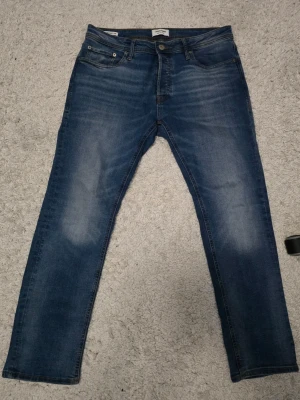 Blå raka jeans från Jack & Jones - Jack & Jones W33 L30. Har lite smuts som syns på bilden utöver det inga fel på den.             snabb affär prioriteras!                                                      Skickas inom 24h