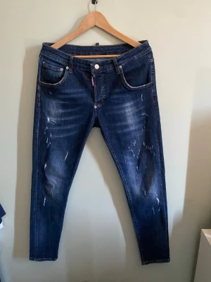 Mörkblå dsq2 jeans med slitningar - Snygga dsq2 jeans i mycket bra skick och bra kvalite. 