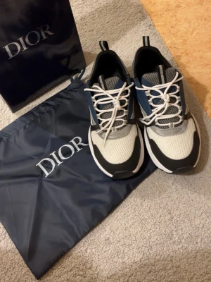  sneakers i mesh och läder - Snygga sneakers i vitt, svart och marinblått med meshpaneler och detaljer i läder. Skorna har tjock vit sula, vita snören och coola kontrastdetaljer. Perfekta för dig som gillar exklusiva och trendiga sneakers med sportig vibe.