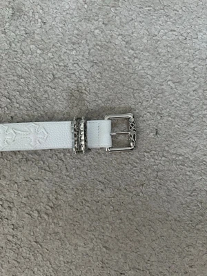 Chrome hearts belt - Snyggt vitt bälte med präglat mönster och coolt spänne i silverfärg. Perfekt accessoar för att lyfta din outfit. Längd: 105cm                                                            kontakta vid intresse eller köp!👍