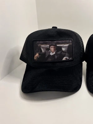 Maggiore Giovinz Scarface Trucker Caps – Nyskick / Limited Style - Säljer 2 st Maggiore Giovinz trucker-kepsar med Scarface/Tony Montana motiv.  Båda är i nyskick och aldrig använda. Velvet/mocka-look framtill med mesh baktill.  Svårare modeller som inte finns överallt längre.  400 kr/st eller 700 kr för båda. Kan skickas! Hör gärna av dig vid frågor!