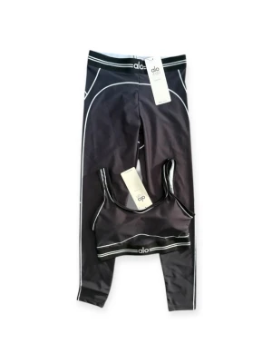 Alo Yoga matching set – NEW with tags - 🔥 Viral workout set – NEW with tags 🔥  Matching set from Alo Yoga – super trendy and perfect for the gym 🖤  ✔️ Sports bra + high-waisted leggings   ✔️ Size S   ✔️ Brand new with tags   ✔️ Sculpting, stretchy & sweat-wicking    Flattering fit that hugs your body and stays in place during workouts 💪 Perfect for gym, pilates, yoga or just that clean “off-duty model” athleisure vibe.  Minimal black design with white details = goes with everything.  ✨ Sold out vibe / influencer favorite    DM if interest