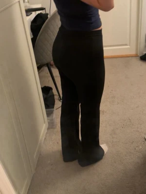 Svarta utsvängda leggings - Säljer ett par svarta leggings från Lager 157, står ej storlek men skulle säga att de sitter som en storlek S. De har en liten slits på insidan längst ner på båda benen. säljer då de ej används.