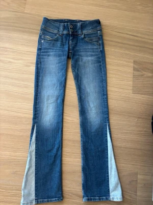 Blå bootcut jeans low waist - Säljer ett par blå bootcut jeans med låg midja. Passar för någon som är cirka 165cm
