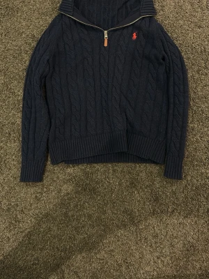 Mörkblå kabelstickad hoodie Polo Ralph Lauren - Mörkblå hoodie från Polo Ralph Lauren.         . Jätte bra skick och pris kan diskuteras!