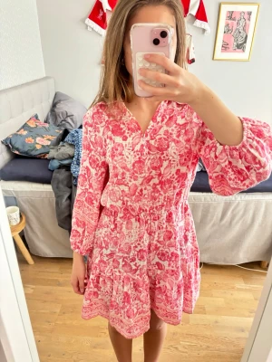 Rosa blommig kortklänning - Rosa blommig Zara klänning som inte finns i deras sortiment längre❣️❣️den är lite sydd i v-ringen men det går enkelt att sprätta upp om det behövs!!