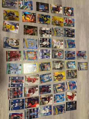 Stort paket fotbollssamlarkort - Säljer ett stort paket med fotbollssamlarkort från olika lag och spelare. Korten har färgglada motiv, olika former av glans och detaljer, samt varierande design. Perfekt för dig som gillar att samla på fotboll eller vill byta med vänner.