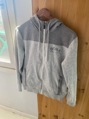 Grå Hugo Boss Hoodie - Snygg och sällsynt hoodie från Hugo Boss i grå. Riktigt fint skick. Storlek S.