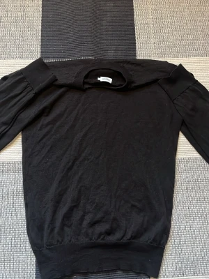 Filippa K stickad tröja  - Säljer en svart stickad tröja från By Malene Birger. Tröjan har rund halsringning, långa ärmar och ribbade muddar. Enkel och stilren design som passar till det mesta. Perfekt för dig som gillar klassiska plagg i garderoben.