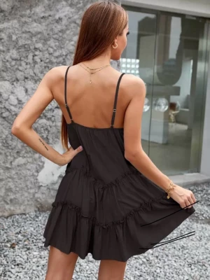 Svart sommarklänning  - Snygg svart kort klänning med tunna axelband och v-ringning. Klänningen har flera volanglager som ger en luftig känsla. Perfekt för varma dagar och enkel att styla med smycken. Tillverkad i ett lätt tyg som känns skönt mot huden.