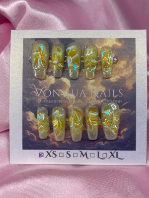 Citrin (XS); Medium Ballerina - Unika press-on naglar i en cool gul nyans med holografiska effekter och abstrakt charms. Naglarna har en glittrig finish och en medium ballerina form. Perfekt för dig som vill sticka ut med en kreativ och trendig nageldesign.XS: 14 mm, 11 mm, 11,5 mm, 10 mm, 8 mm 