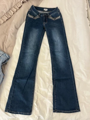 Jeans från madlady  - Jag säljer ett par jeans från madlady, färgen: vintage blue. Låg midja har klassisk bootcut-passform men bak- och sidofickor. Designade med hällor och gylf med dragkedja.