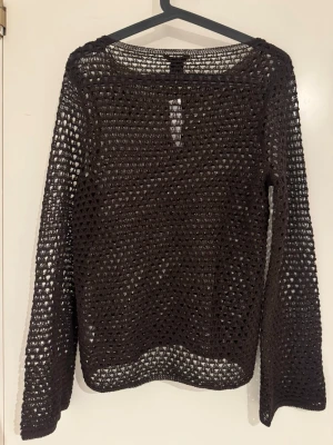 Brun virkad tröja från Gina Tricot - Säljer en brun, långärmad virkad tröja från Gina Tricot. Tröjan har ett genombrutet mönster och rund halsringning. Perfekt att styla över ett linne eller bikini. Materialet känns mjukt och luftigt.