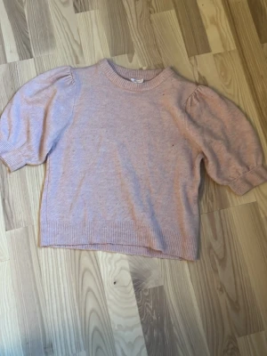 💞Ljusrosa stickad tröja💞 - Söt ljusrosa stickad tröja från gina tricot med puffärmar och ribbade muddar vid hals, ärmslut och nederkant. Perfekt för dig som gillar en mjuk och feminin stil. Tröjan har en klassisk rund halsringning och är tillverkad i ett mjukt material. Väldigt trendig. Ny pris runt 300 tror jag. Men mitt pris är inte satt så 