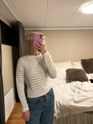 Vit stickad tröja från MNG - Vit stickad tröja från MNG med ett grovt, luftigt stickat mönster. Tröjan har rund halsringning och långa ärmar. 