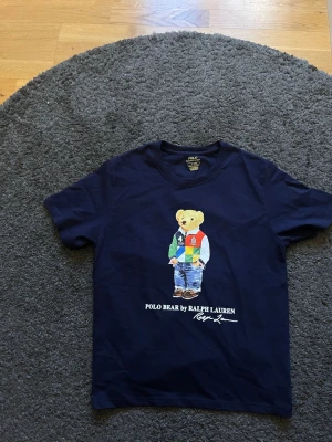 Ralph Lauren T-shirt  - Säljer en snygg mörkblå T-shirt från Ralph lauren. Säljer pga att den var förliten för mig. Priset kan diskutera kom pm.