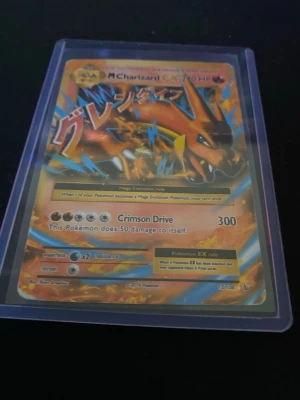 Pokémonkort Mega Charizard EX - Säljer ett samlarkort av Mega Charizard EX från Pokémon, med färgstark design i orange, blått och gult. Kortet är på engelska och ligger i ett genomskinligt plastfodral. Perfekt för dig som gillar Pokémon och vill utöka din samling.