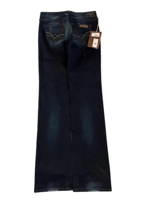 Bootcut jeans  - Supersnygga lågmidjade Les temps des Cerises Jeans med broderi fickor och ljusa slitningar framtill och baktill. Finns en liten springa på högra baklåret, däremot är det inte igenom hela tyget så det är inte ett hål. W29