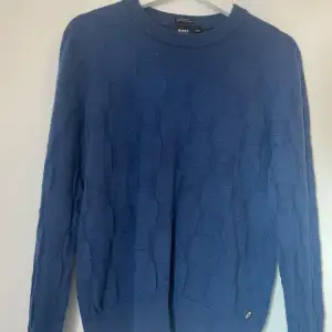 Säljer denna snygga och stilrena tröja från Hugo boss som har ett unikt tryck. Den är i väldigt fint skick och har inte använts särskilt. Hör av er om ni har några frågor eller funderingar!