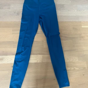 Blåa träningsthights från Nike  - Sköna långa träningsthights från Nike i storlek M men passar även om man brukar ha S