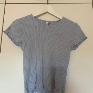 Ljusblå t-shirt - Ljusblå t-shirt i storlek XS, ribbat material & något croppad i modellen 