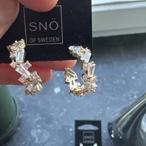 Överhängen  - Örhängen 