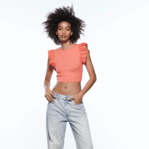 Topp med volanger - Säljer den här fina korallfärgade volangtoppen från zara💗använd endast ett fåtal gånger, storlek S💕nypris 119kr, jag säljer för 40kr + frakt🥰