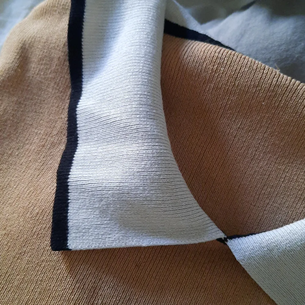Stretchig tröja i lite mörkare gul/brun nyans. Hela tröjan är av samma material.. Tröjor & Koftor.