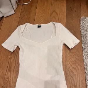 T-shirt  - Enkel tshirt med v-ringning. Perfekt bastopp! Använd en gång. Sitter lite tajt/figurnära 