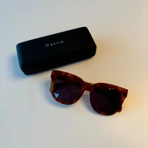 Corlin Eyewear - Supersnygg solgalsögon från Corlin i modell Monza, färg Tortoise brown.  Säljer pga att modellen inte passade mig. Använd några gånger, har en liten repa på glaset. Se sista bilden. Annars i bra skick. Säljs med box + liten påse Nypris 1 299kr