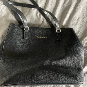 Valentino väska - Valentino väska köpt på zalando. Väldigt rymlig, med två fack och magneter så man kan stänga den. Perfekt att ha som skolväska. 