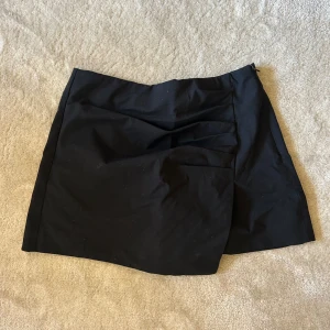 Kostym shorts  - Super fina kostym shorts från zara! Svarta med detalj framtill som gör att de ser ut som en kjol. Perfekta både i sommar och till höst! 