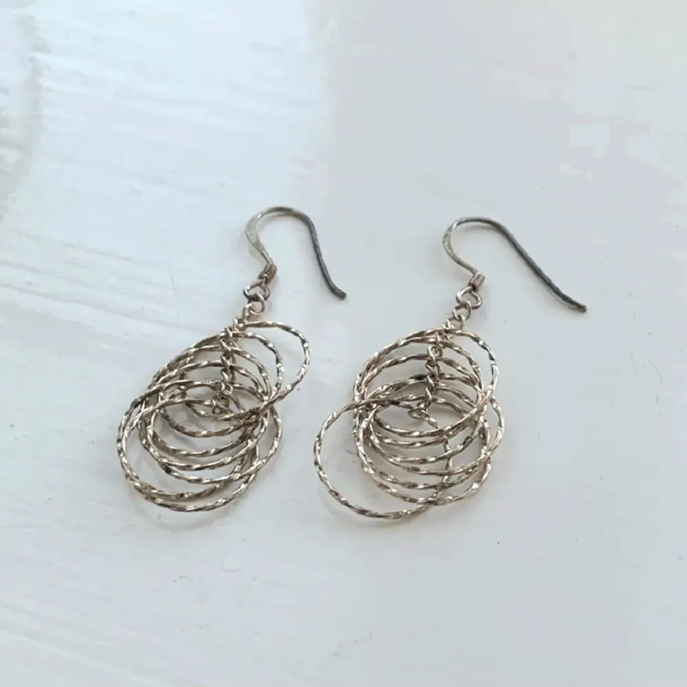 Ett par jättefina örhängen i silver med flera ringar. Märkta med sifforna 925 vilket indikerar att det är äkta sterling silver.  Knappt använda och i bra skick!. Accessoarer.