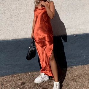 Satinklänning - Orange/röd satinklänning med djup rygg. Använd 2 gånger.