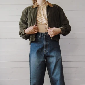 Manchesterjacka med krage - Grön manchesterjacka med en krage. Kragen är brun och gjorde av fake läder. Perfekt vår eller höstjacka. Jackan är i storlek S och från märket Lizsport. Yttre tyget: 100% bomull. Inre tyget: 100% polyester.