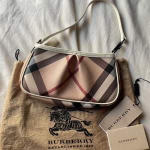 Äkta burberry shoulder bag - En jättefin och trendig äkta burberry aston nova shoulder bag i perfekt skick. Dustbag, prislappar och äkthetsbevis medföljer.  Nypris: ca 8000 kr