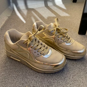 Guldiga sneakers - Helguldiga sneakers ifrån märket Rapter i storlek 38. Använd några gånger men de är i princip i nyskick. Snörena är guldglittriga