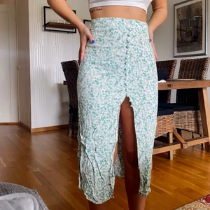 Kjol - Härlig blommig kjol! Säljer billigt pga två knappar som gått sönder som man ser på sista bilden. Annars fint skick! Använt 1 gång. 💚