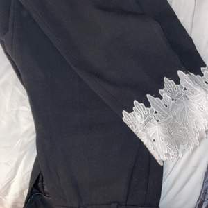 Black pants, with white detail embroidered ankle. As new 